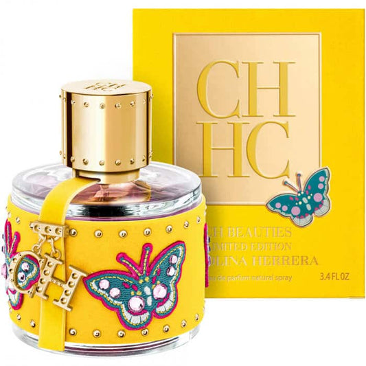 Elegante botella rosa de perfume CH Beauties Carolina Herrera con diseño de corazón y detalles dorados
