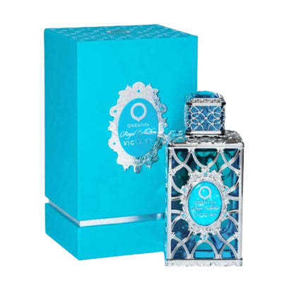 Botella dorada Orientica Victory Royal Collection 80ml con diseño de corona y detalles rojos