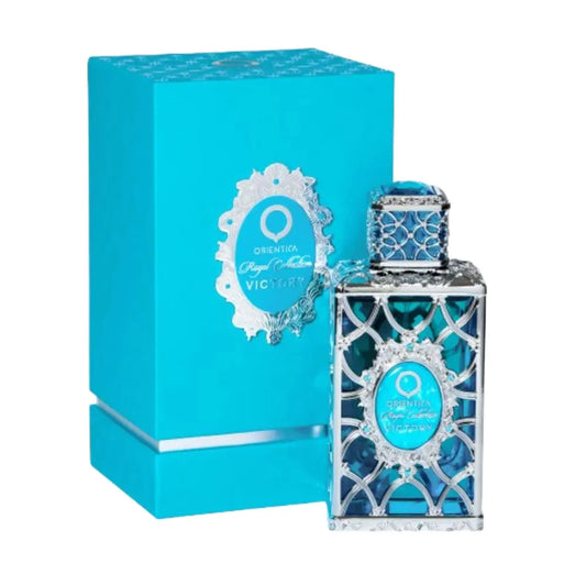 Botella dorada Orientica Victory Royal Collection 80ml con diseño de corona y detalles rojos